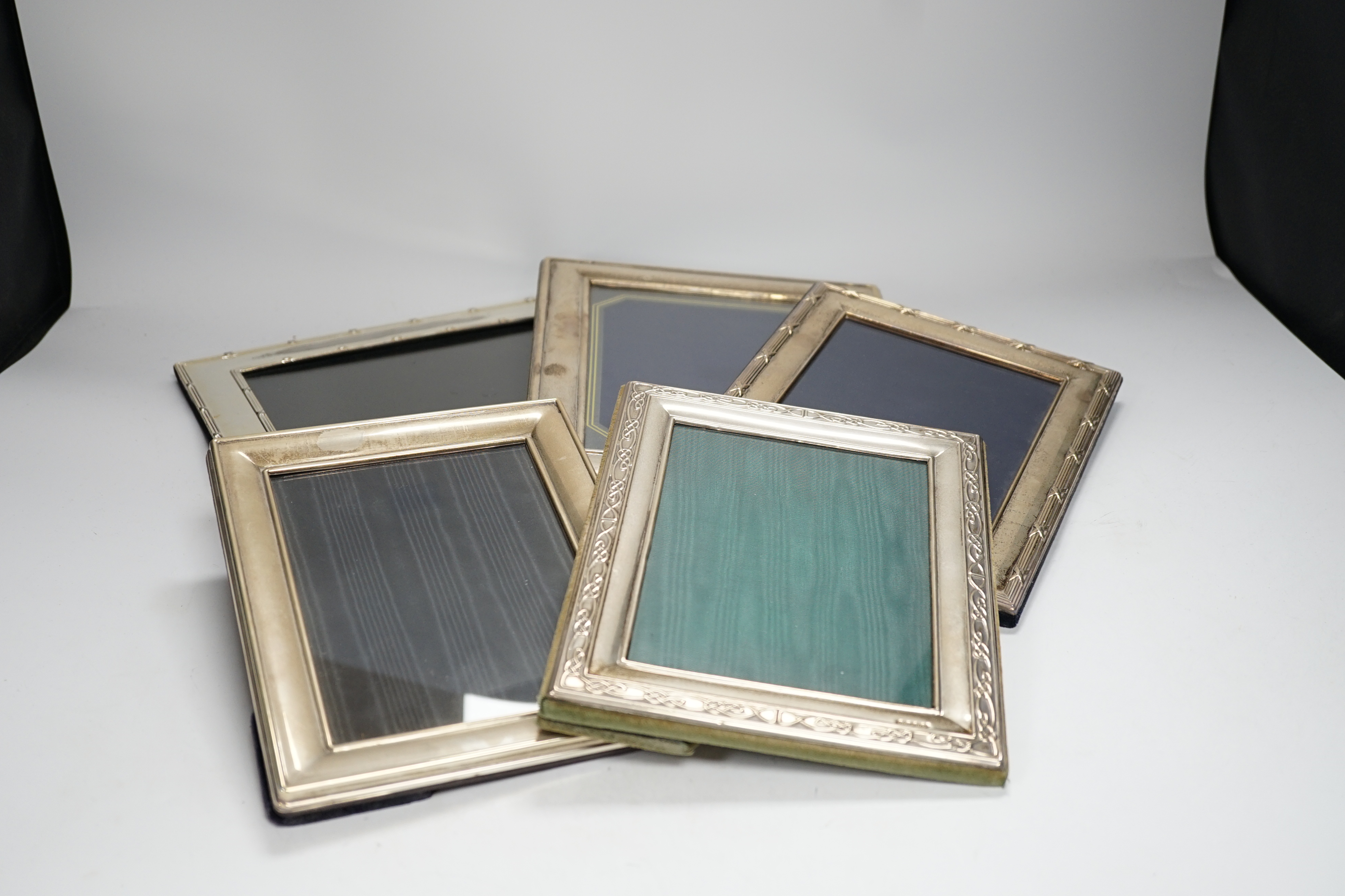 Four assorted modern silver mounted photograph frames, largest 25.9cm and one silver plated photograph frame.